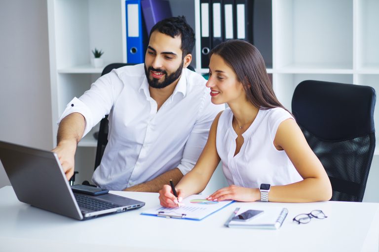 Young smiling business woman and business man.